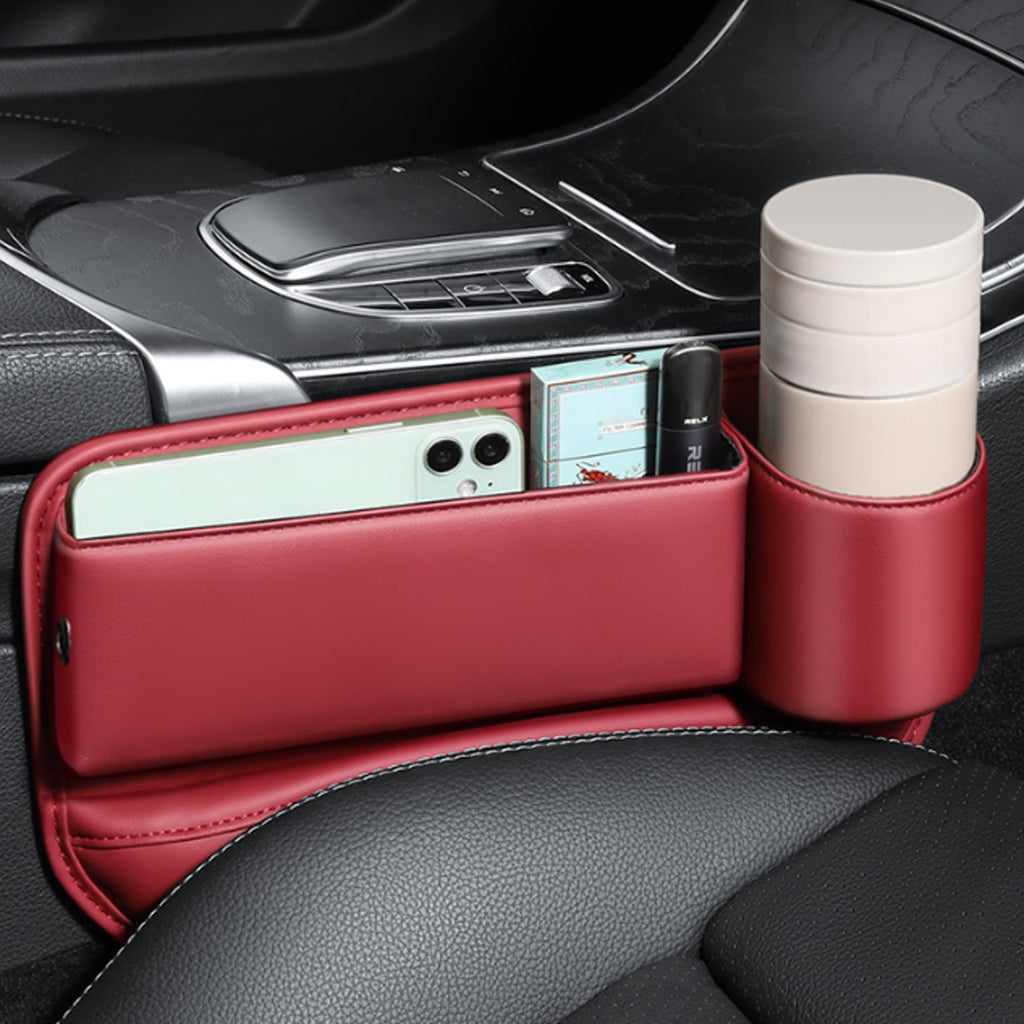Red gap organizer with phone, cards and a cup in the holder