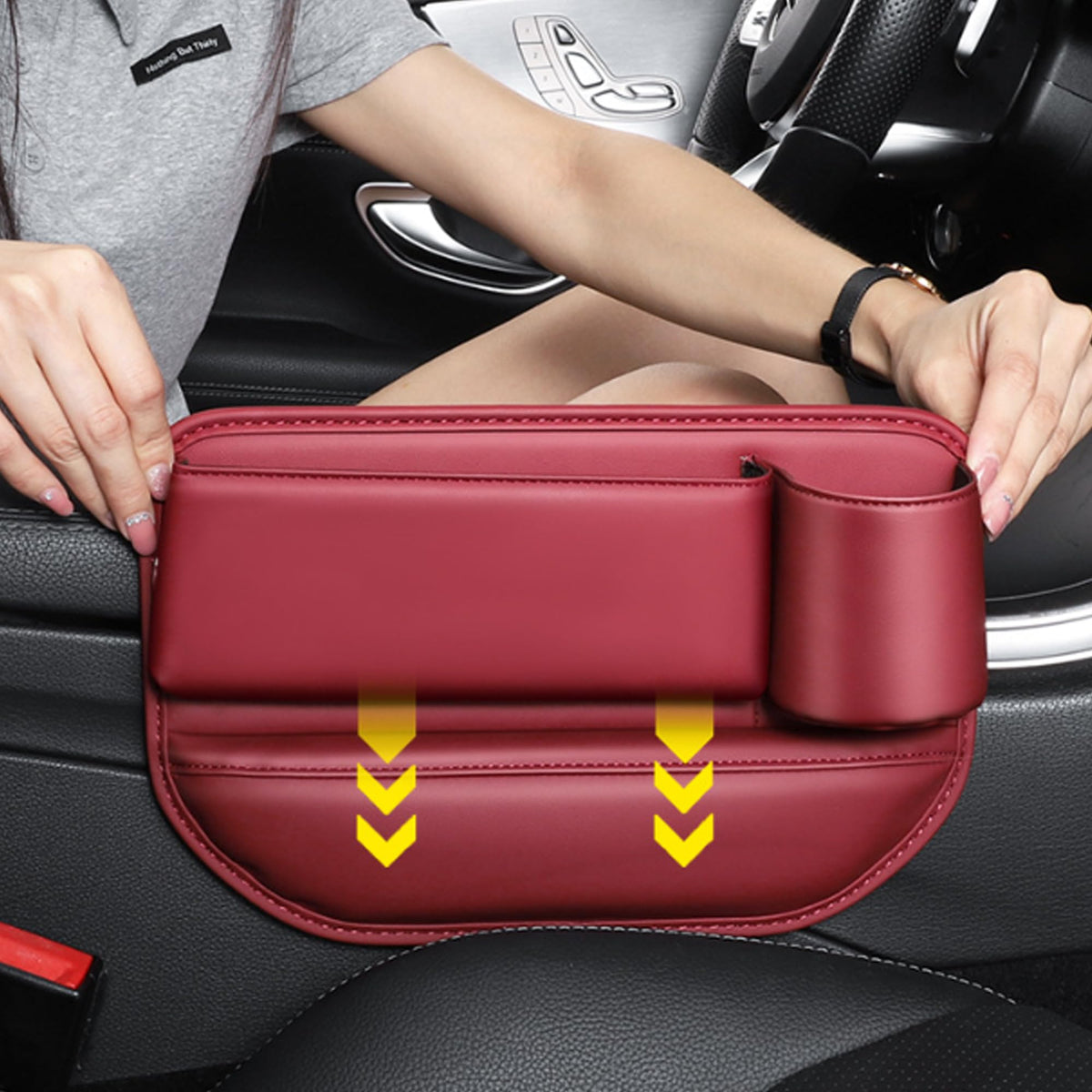 Sliding the red gap filler organizer between seat and console